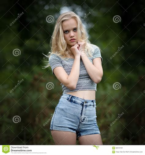 bautiful blonde tiener alleen in het hout stock afbeelding