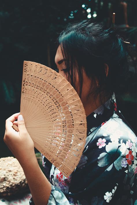 japanese woman holding brown hand fan  stock photo