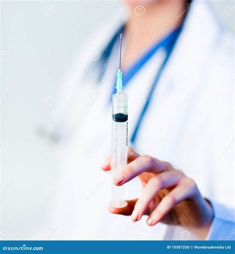 doctor holding  needle royalty  stock  image