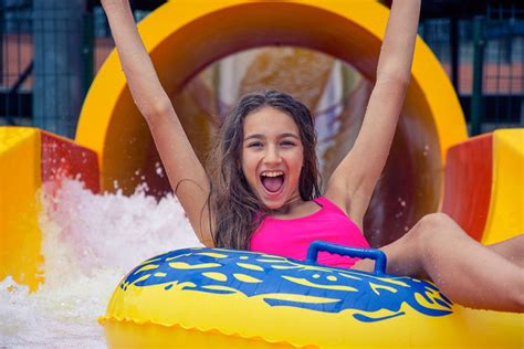 cheerful girl  hands   fun sliding  water park  inflatable ring swim jim