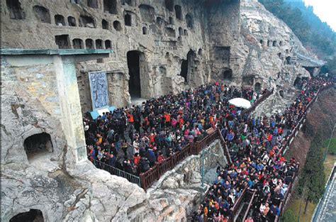 Tourists Throng The Longmen Grottoes In Luoyang Henan
