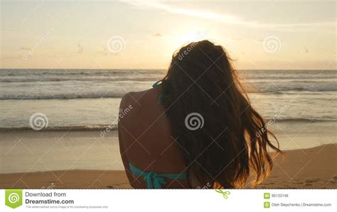 Beautiful Young Woman In Bikini Standing Near The Sea On Sunset