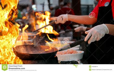 professional chef   commercial kitchen cooking flambe style stock photo image