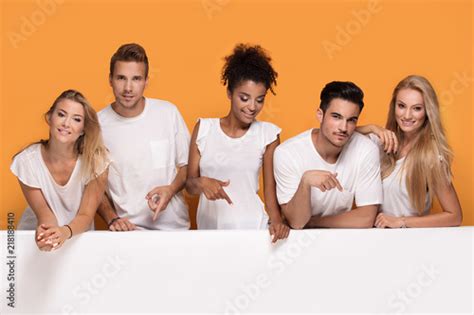 people posing  white empty board buy  stock photo