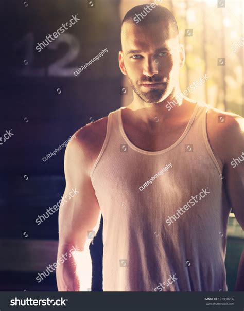 Sexy Portrait Of Masculine Man With Shaved Head In Hard Dramatic Light