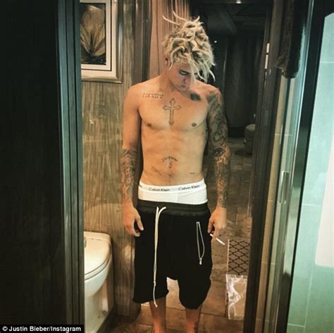 justin bieber appears to use post malone s arm as an ashtray at houston club daily mail online