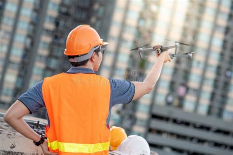 young asian engineer holding drone  construction site stock image image  control