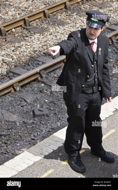 british railways guard  pointing stock photo alamy