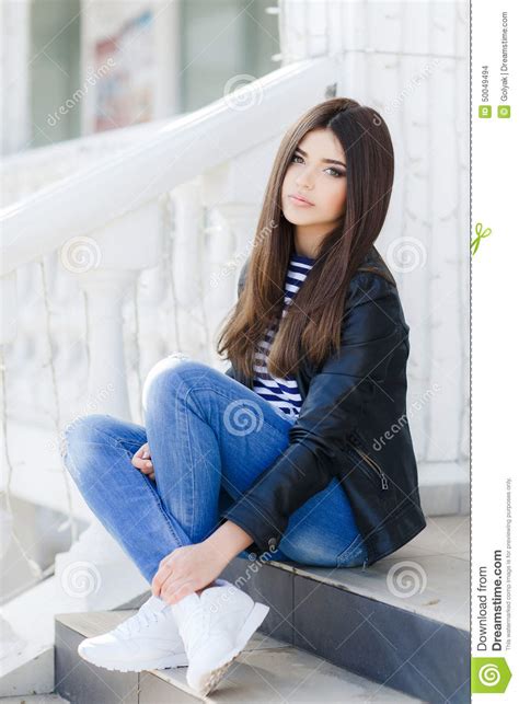Portrait Of A Beautiful Woman Sitting On The Steps Stock