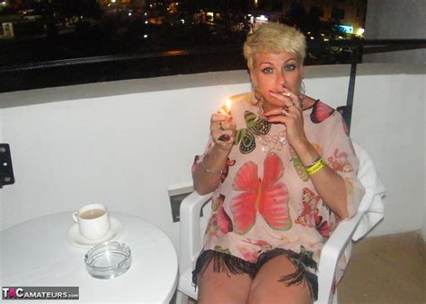 sexy mature woman dimonty gets naked after smoking a cigarette on balcony
