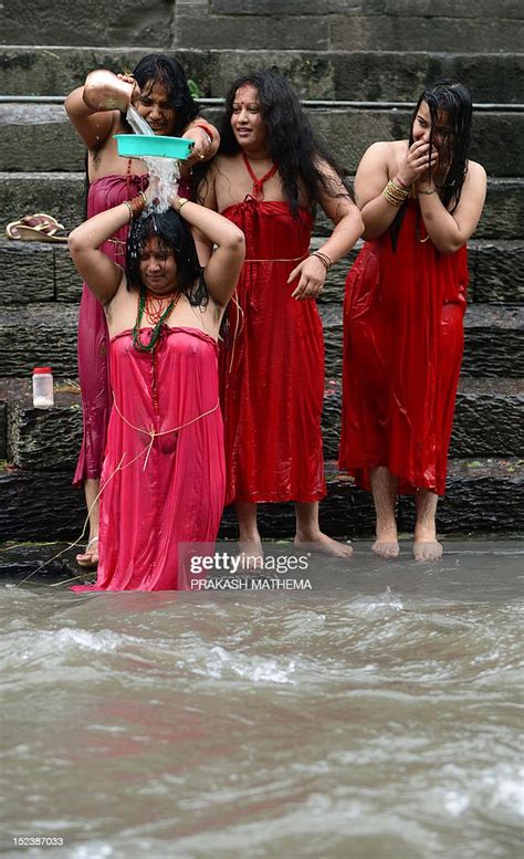 nepalese hindu women take a ritual bath in the bagmati river during