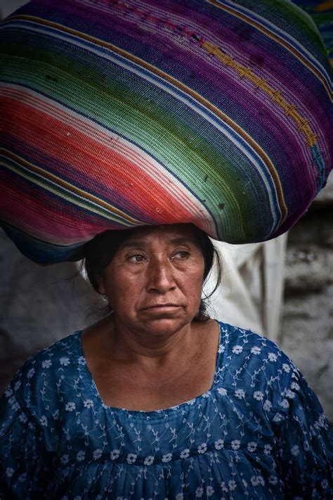 Woman Carrying A Bundle On Her Head In The Marketplace