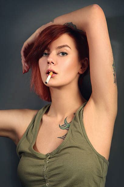 Beautiful Girl With Tattoo Smoking A Cigarette Stock