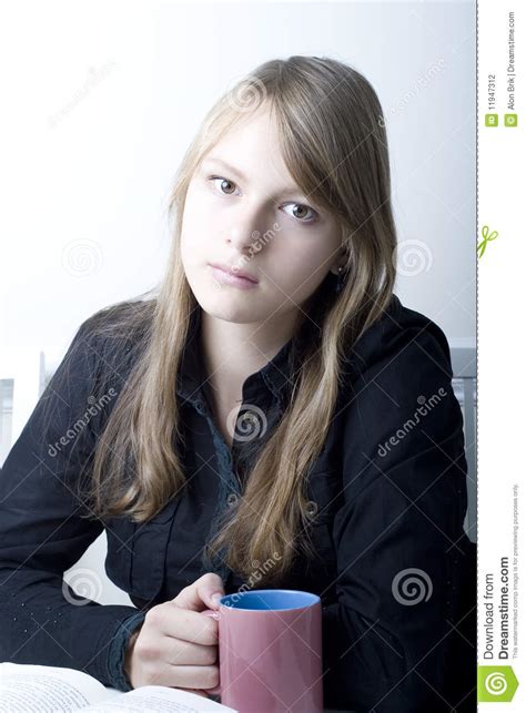 teenage girl with long blond hair sitting stock