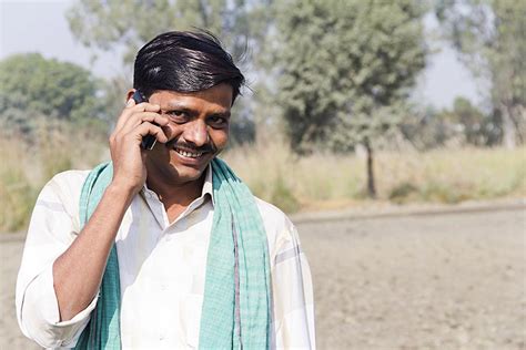 indian villager farmer talking  mobile phone  field village