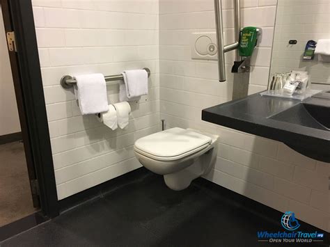 Photo Description Toilet In Hotel Bathroom With Grab Bar Along Wall