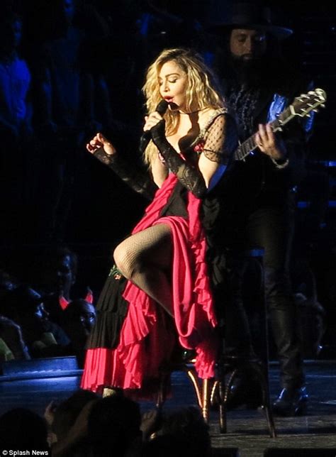 madonna pulls down a female fan s top and exposes her bare breast in