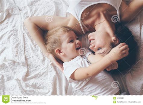 mom relaxing with her little son stock image image of bedding still 60157501