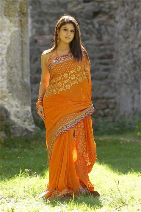 sexclusive stills nayanthara beautifully exposing her hot curves in orange saree