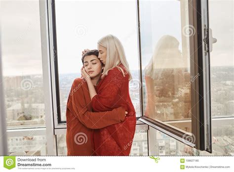 portrait of attractive lesbian couple in love wearing red clothes