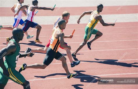 relay runners racing  track athletic people stock photo