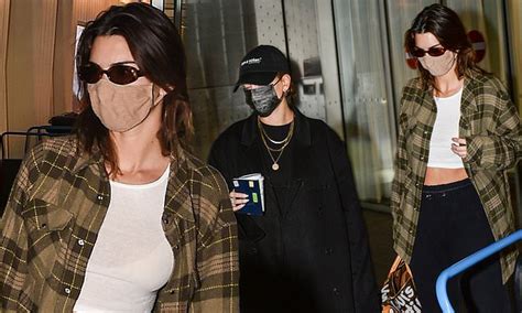 kendall jenner flashes her abs as she and pal hailey bieber arrive at