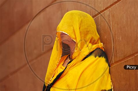 image of indian traditional woman covering her face with veil zl645682