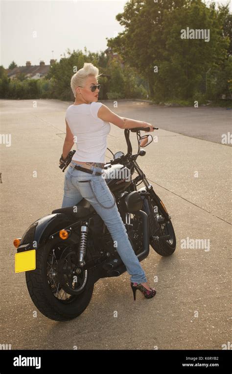 Beautiful Short Haired Blonde Girl With A Harley Davidson Motorcycle