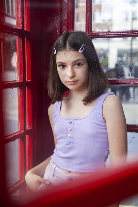 Teenage Girl In Pink And Purple Pants And Top With Hair Clips Short