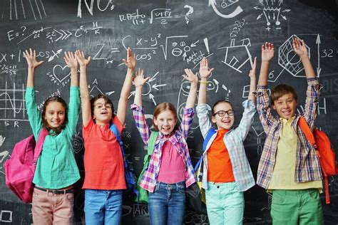 group  happy schoolchildren standing  front   blackboard