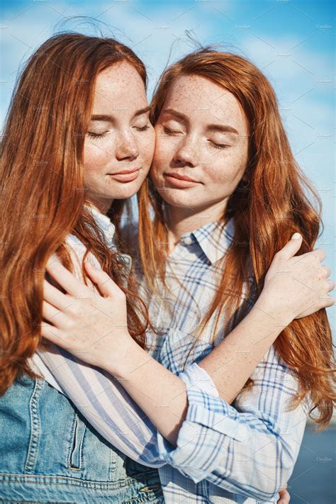 Portrait Of Red Haired Twin Sisters Hugging Each Other