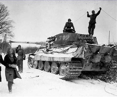 Two American Soldiers Inspect A Destroyed German King