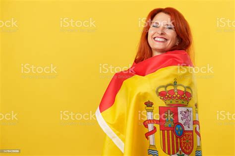 Happy Redheaded Mature Woman Wrapping With A Spanish National Flag
