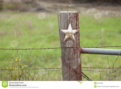 Selective Focus View Of Grungy Star On Old Fence Post In