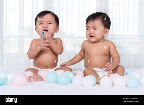 twin babies crying   bed stock photo alamy