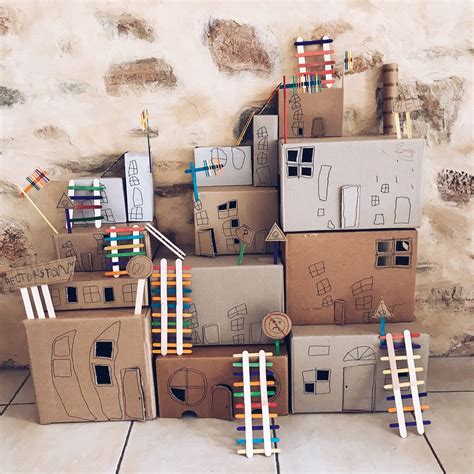 cardboard boxes stacked  top     front   brick wall  clothes pins