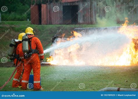 firefighters spraying high pressure water  fire  copy  royalty  stock image