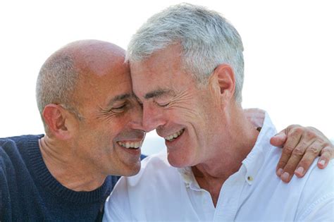 mature older senior gay male couple smiling and affectionate stock