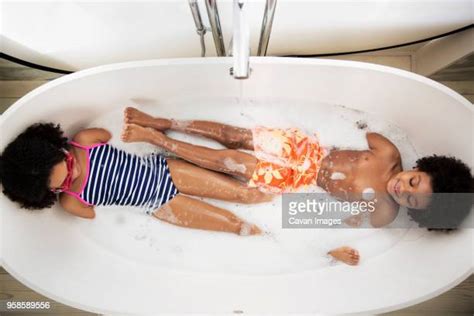 Brother And Sister Playing In Bath Tub Photos And Premium High Res
