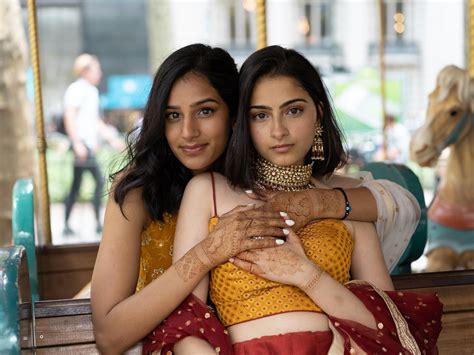 a same sex couple took pictures in traditional south asian clothes and