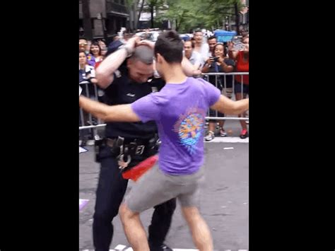 a gay pride parade marcher got an nypd cop to bust a move with him and
