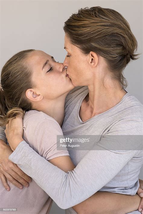 mother is kissing her daughter photo getty images