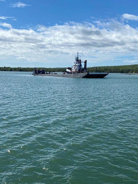 barge loaded with diesel fuel and coal tar runs aground near upper