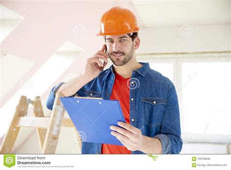 young handyman   mobile phone stock photo image  craftsman project
