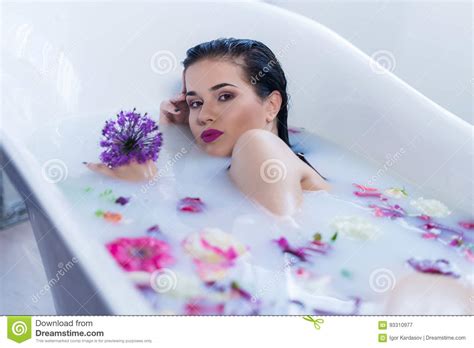 brunette woman relaxing in a hot bath with flowers stock image image
