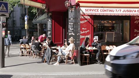 busy street cafe  cyclist  car passing   centre  paris