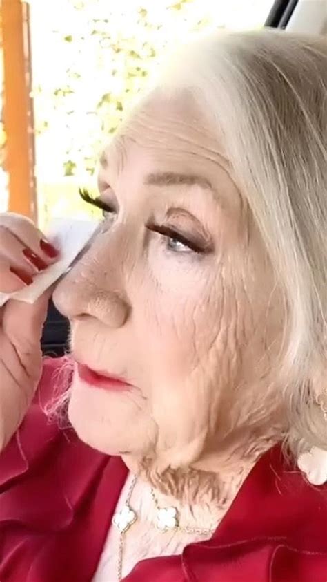 An Older Woman Getting Her Make Up Done In The Back Seat Of A Car