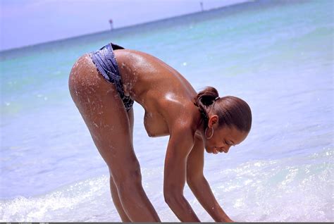 oiled up model tierra love struts along the beach in her