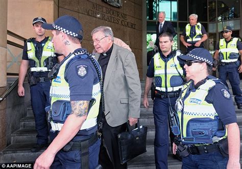 police officer flanking cardinal george pell sports neck