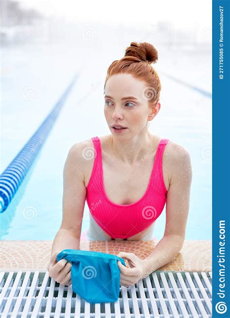 Pretty Awesome Ginger Woman Putting On Swim Cap At The Pool Stock Image